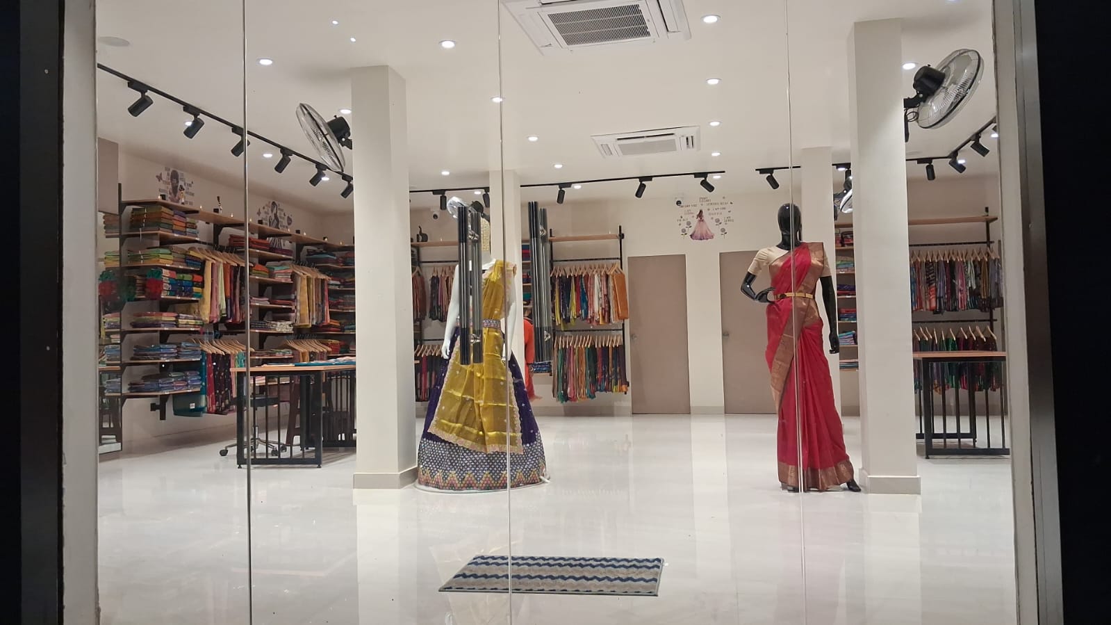 Mannequin in maroon saree, center of store